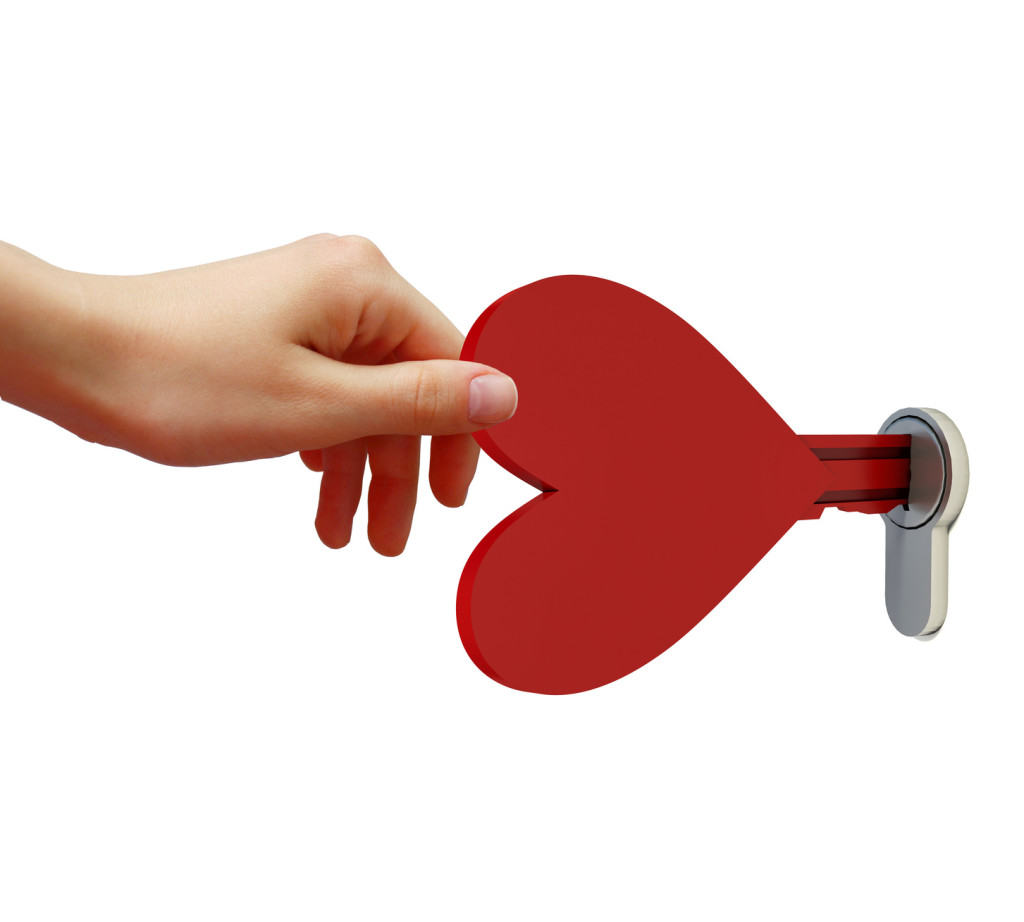 Human hand opens the lock key in the form of heart